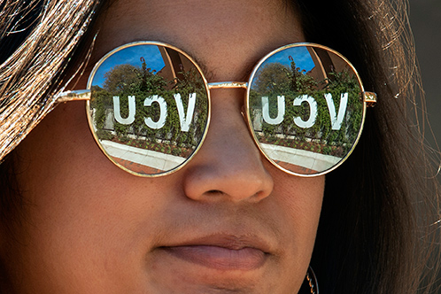 The VCU sign is reflected in a student's sunglasses