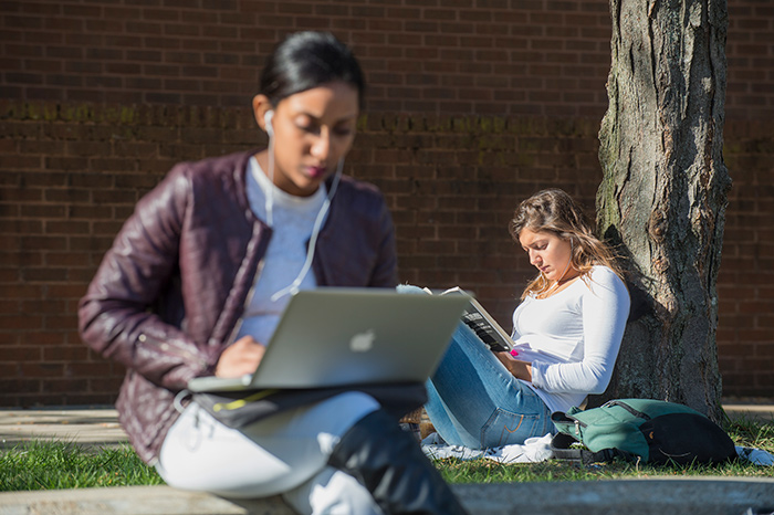 Two students study on campus